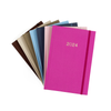 A fan of seven different coloured planners: brown, beige, sage, blue, navy, pink, fuchsia
